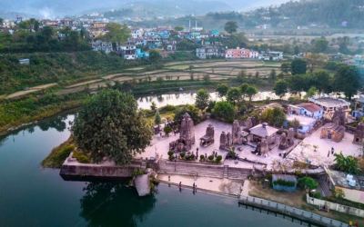 Ancient stone temples surrounded by water in the Baijnath Valley
